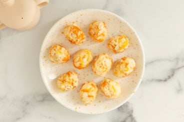 Chicken and rice balls on white plate.