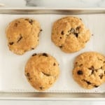 Cinnamon raisin bagels on baking sheet after baking.