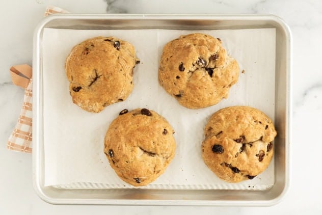 Cinnamon raisin bagels on baking sheet after baking.