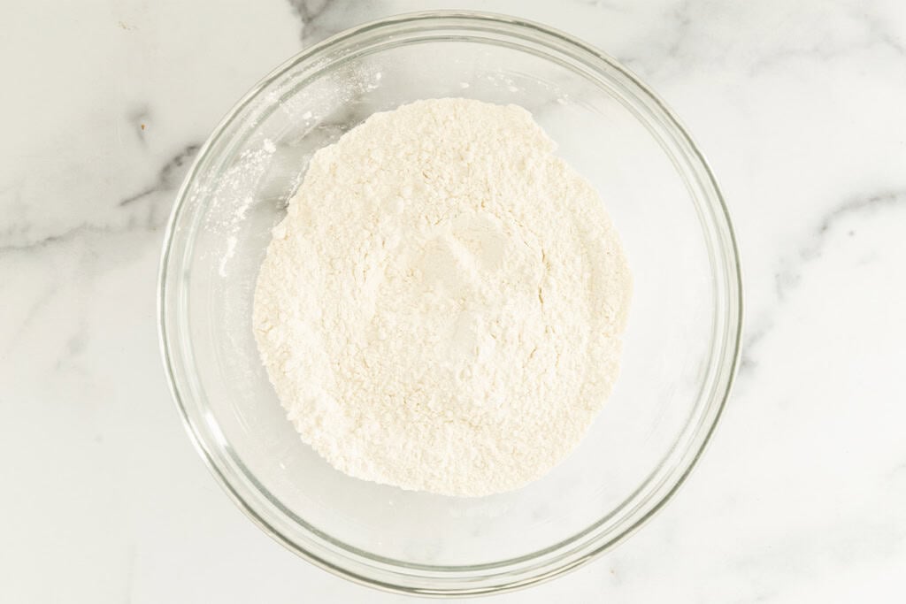 Dry ingredients in glass bowl for cottage cheese waffles.