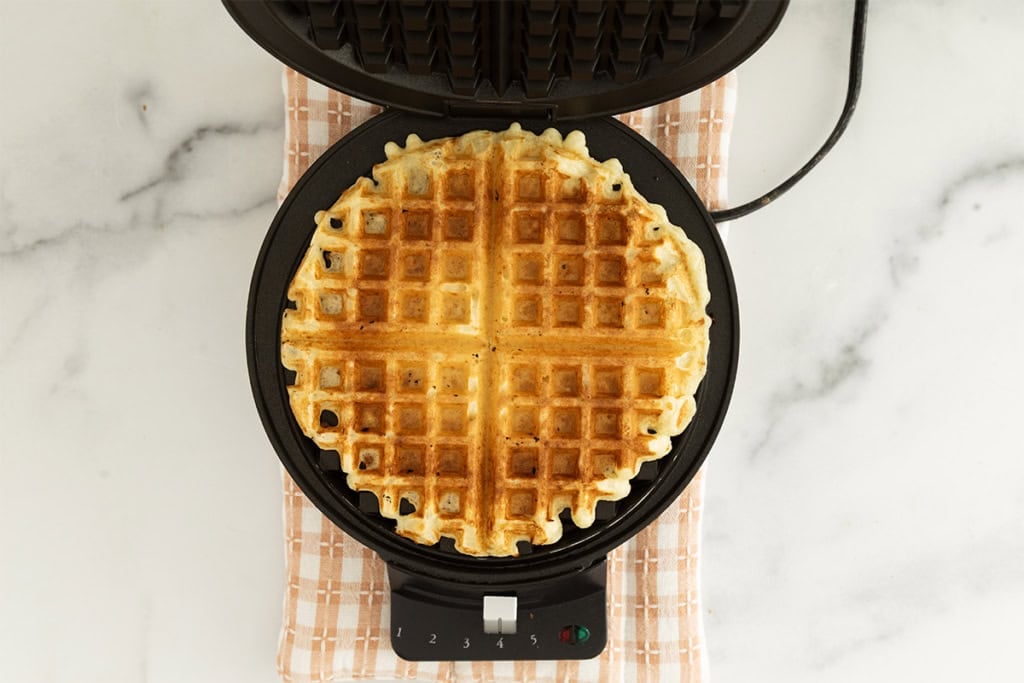 Cottage cheese waffles on waffle iron after cooking.
