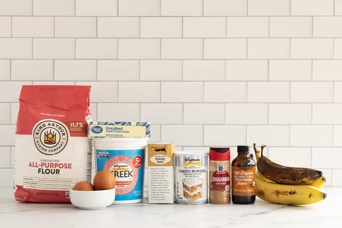 Ingredients for greek yogurt banana muffins on countertop.
