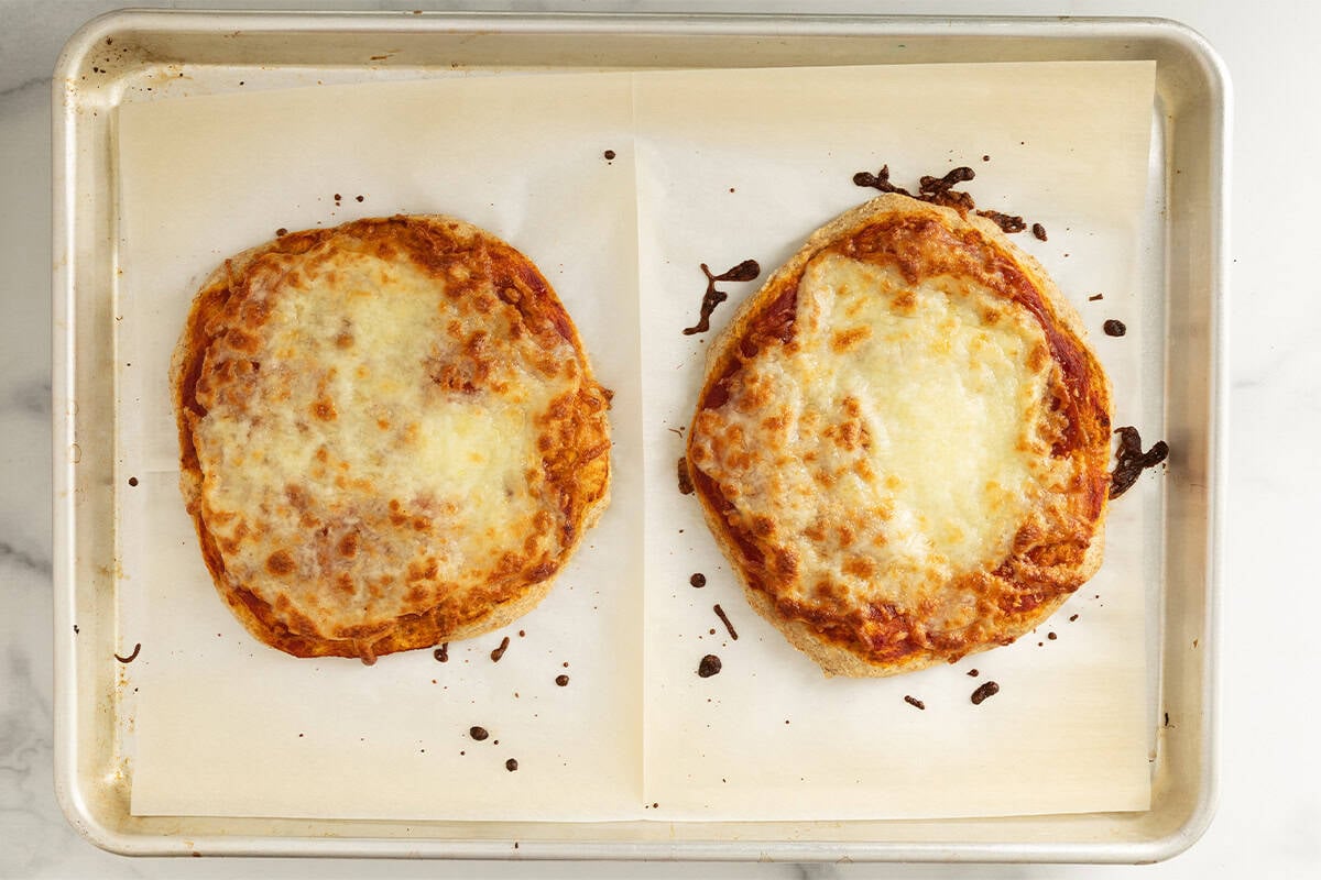 baked pizzas on baking sheet.