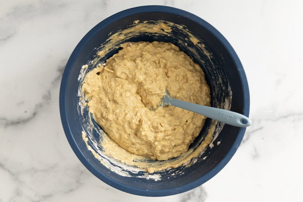 Batter for blueberry oatmeal muffins in blue bowl.