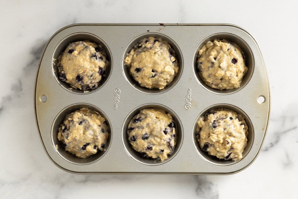 Blueberry oatmeal muffins in muffin pan before baking.