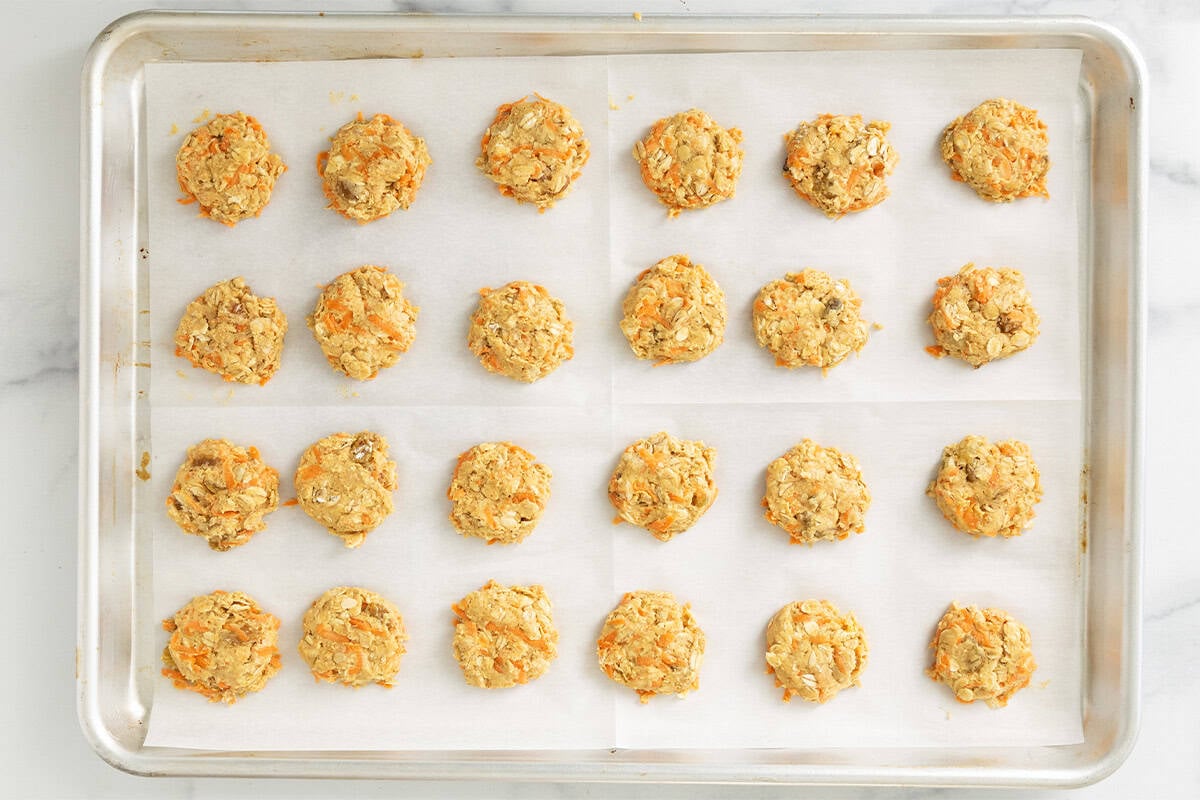 Carrot oatmeal cookies on baking sheet before baking.
