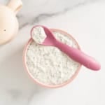 Chia pudding overnight oats in pink bowl with pink spoon.