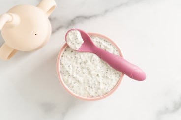 Chia pudding overnight oats in pink bowl with pink spoon.