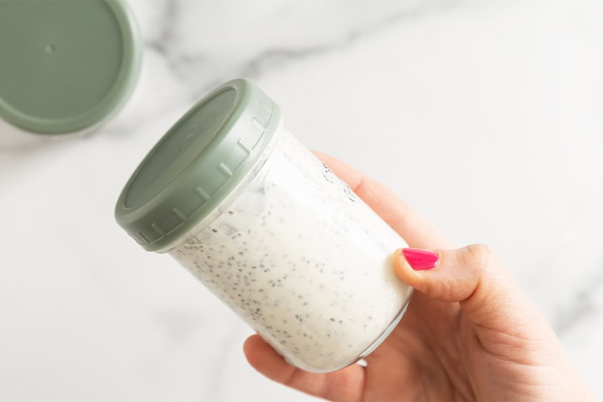 Chia pudding overnight oats in glass jar with green lid.