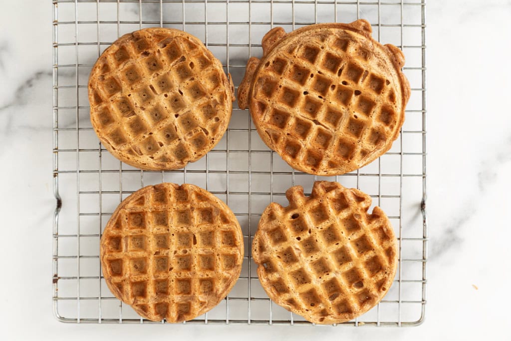 Chocolate waffles on cooling rack.