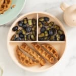 Chocolate waffles on kids plate with blueberries.