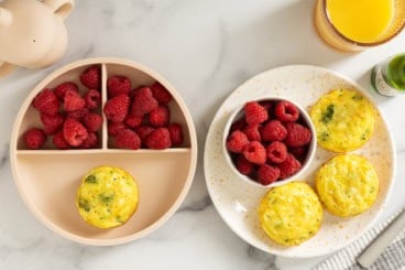 Cottage cheese egg bites on plate with raspberries.