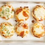 mini pizzas on baking pan.