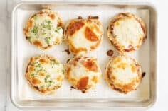 mini pizzas on baking pan.