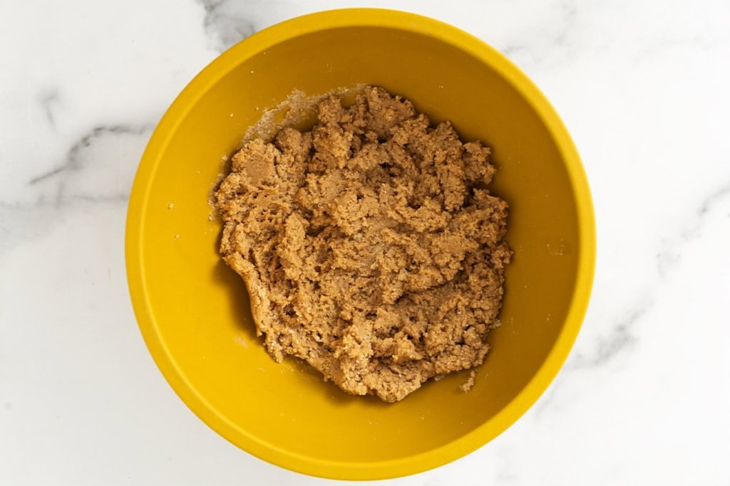 Batter for peanut butter eggs in yellow bowl.