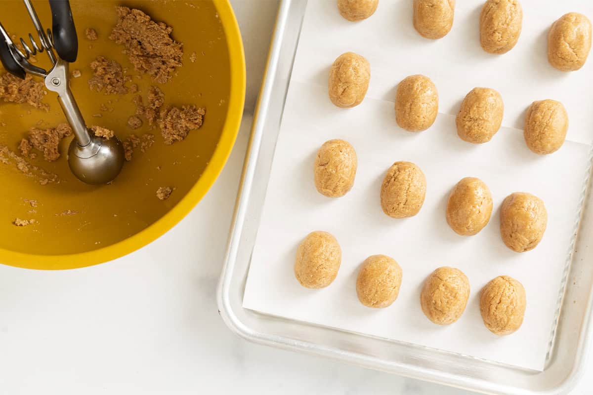 Making peanut butter eggs on parchment paper.