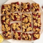 Raspberry oatmeal bars on white plate.