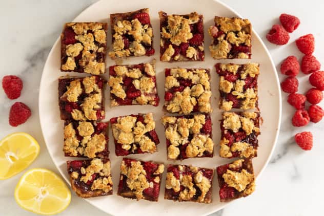 Raspberry oatmeal bars on white plate.