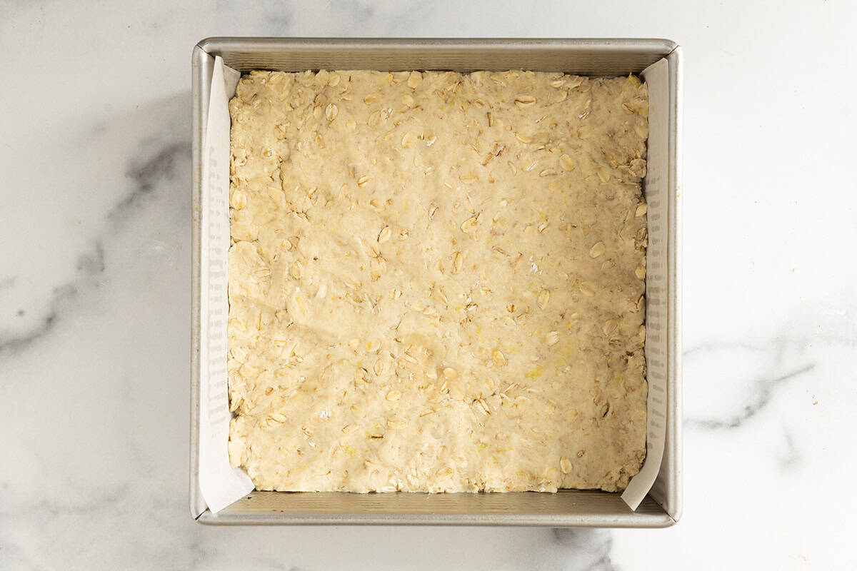 Crust for raspberry oatmeal bars pressed into pan.