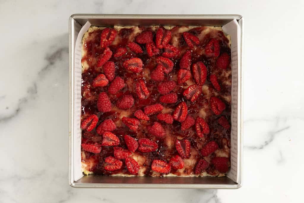 Raspberry oatmeal bars in pan before adding topping.