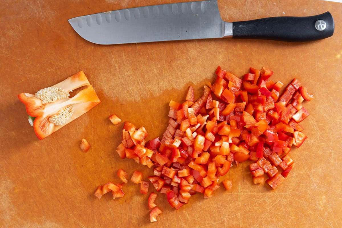 Chopped pepper on cutting board for veggie egg bake.
