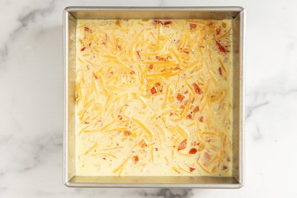 Veggie egg bake in pan before baking.