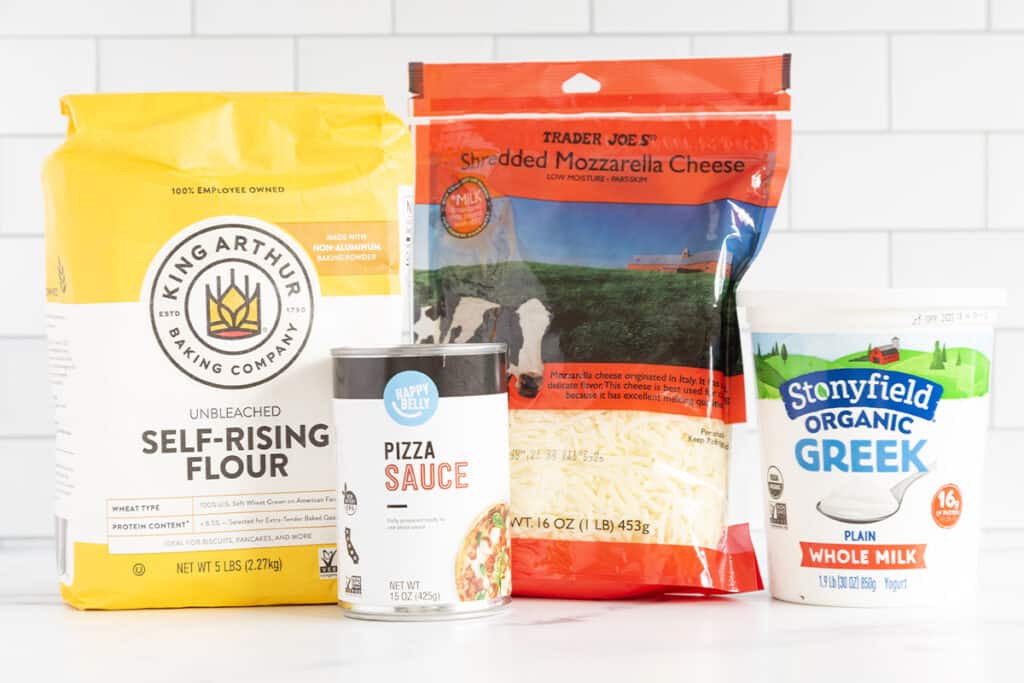 ingredients in baby pizza on counter.