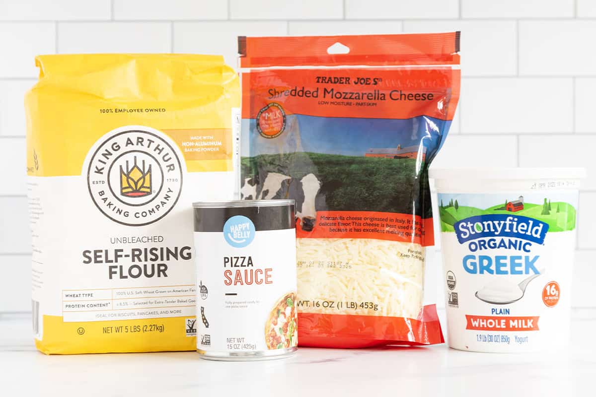 ingredients in baby pizza on counter.