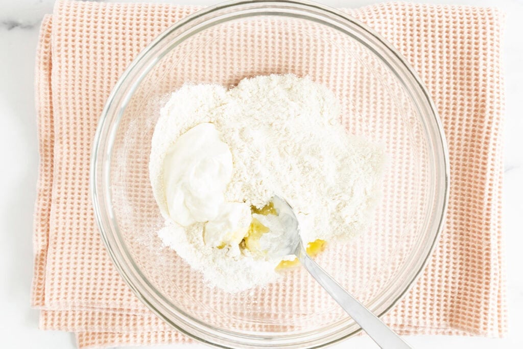 ingredients for baby pizza crust in glass bowl.
