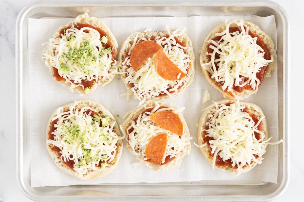 mini pizzas with toppings on baking pan.