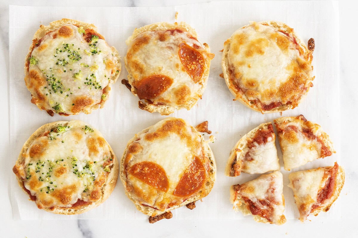 baking and sliced mini pizzas on pan.