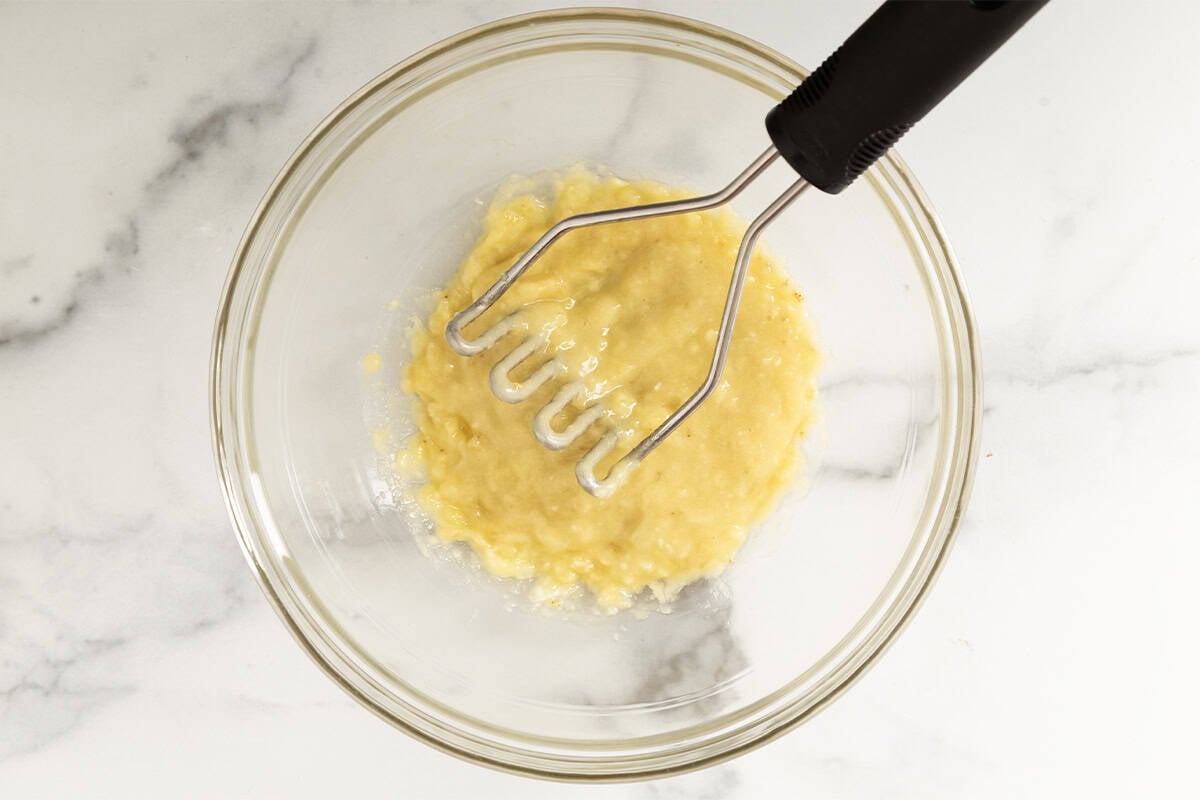 Mashing banana for blueberry pancakes. 