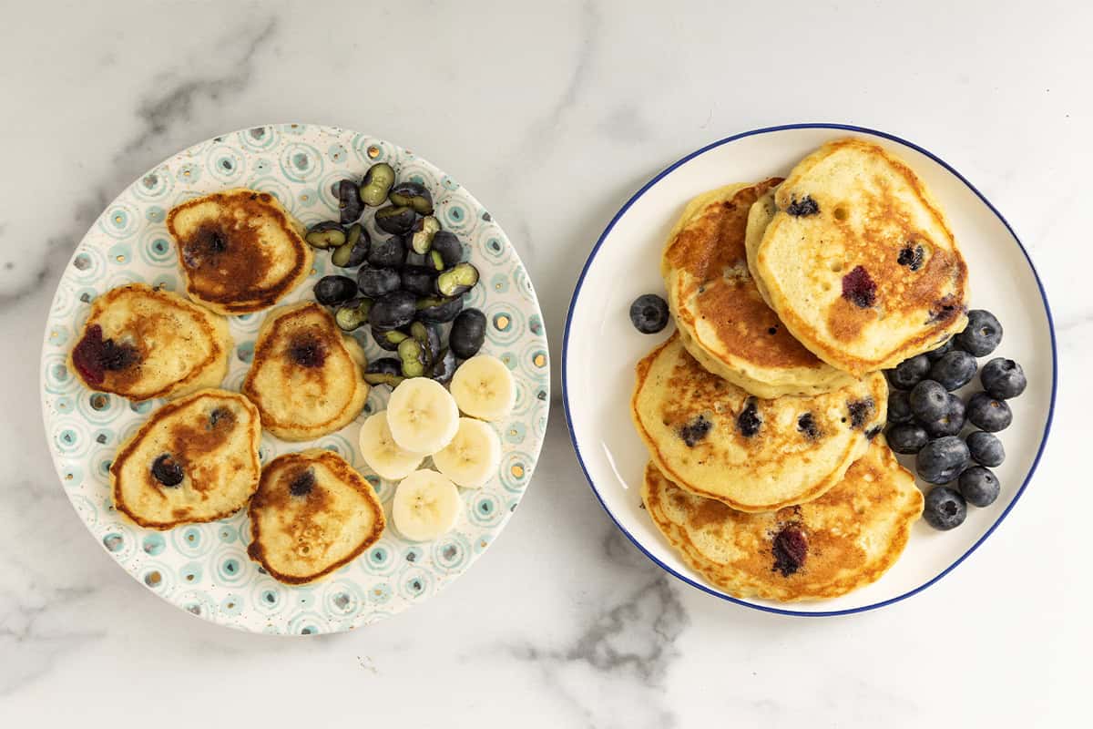 Blueberry banana pancakes on two plates.