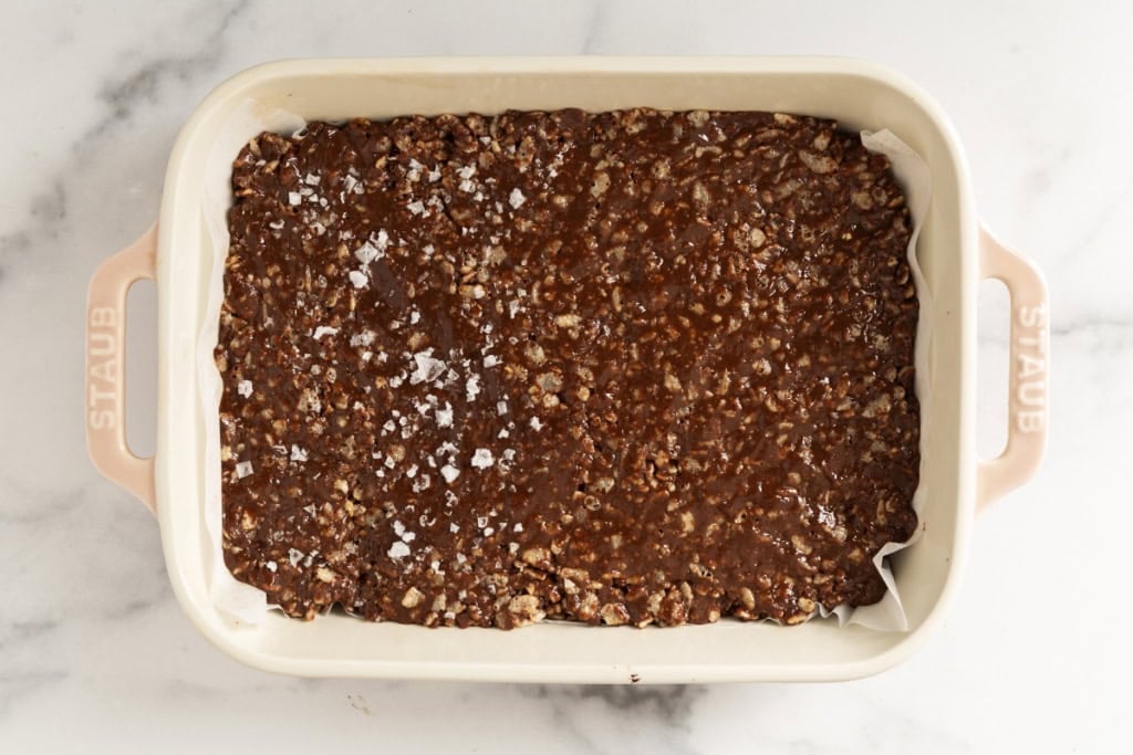 Chocolate crunch bars in white pan.
