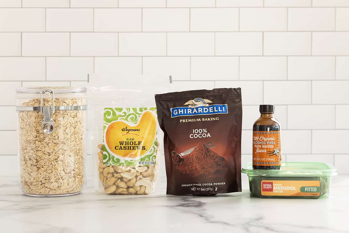 Ingredients for chocolate date balls on countertop.