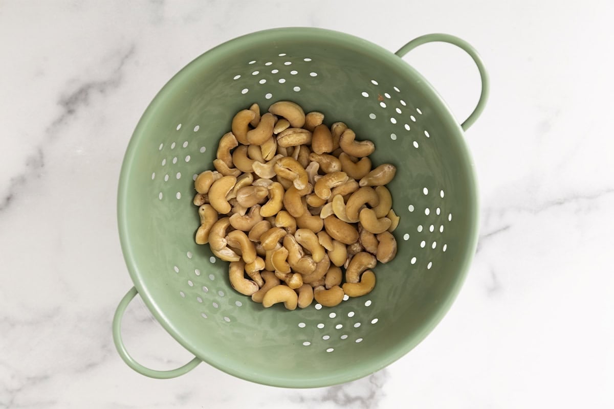 Cashews in strainer for chocolate date balls.