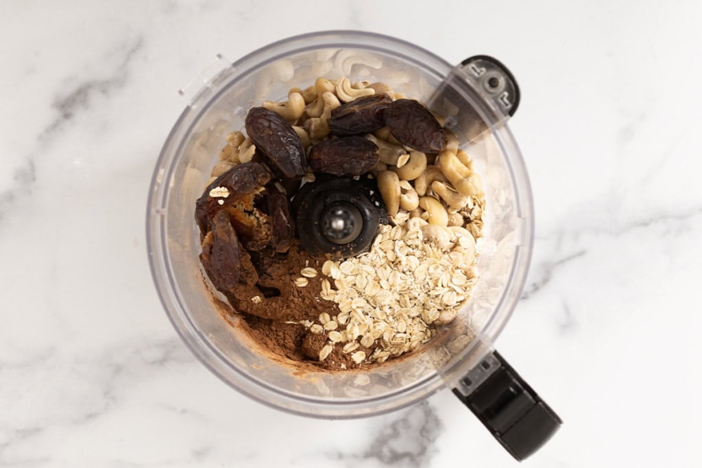 Ingredients for chocolate date balls in food processor.
