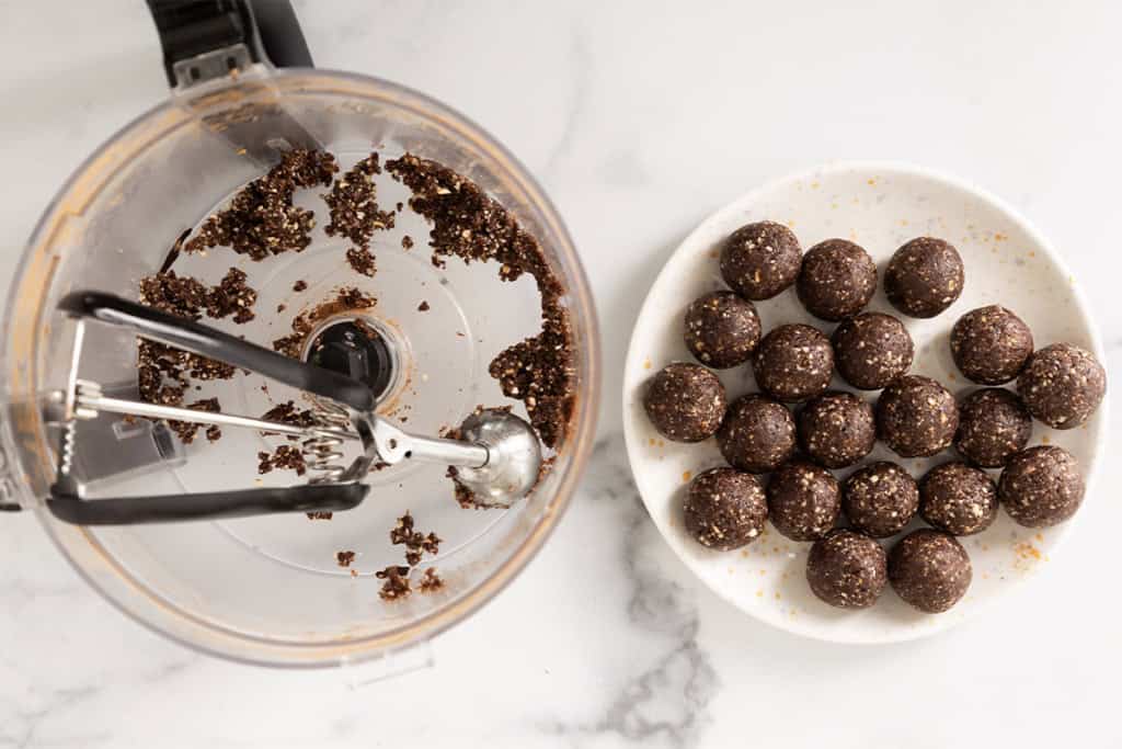 Making chocolate date balls with ice cream scoop.