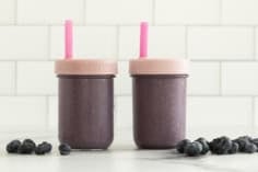 Hi fiber smoothie in two cups with lids and straws.