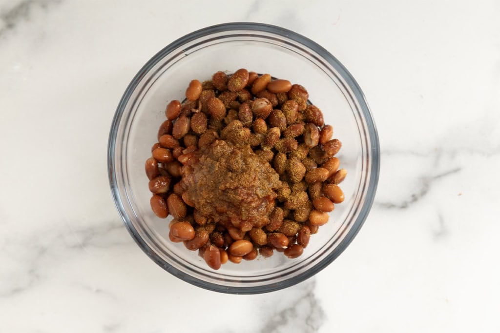 Beans and seasonings in glass bowl.