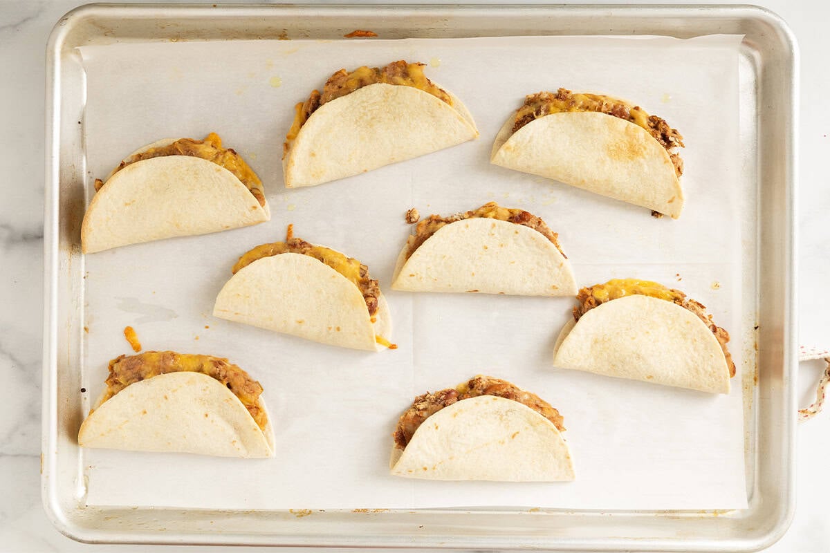 Mini tacos on baking sheet after baking.