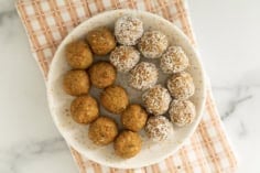 Carrot balls on white plate and towel.
