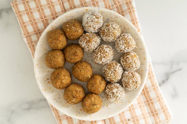 Carrot balls on white plate and towel.