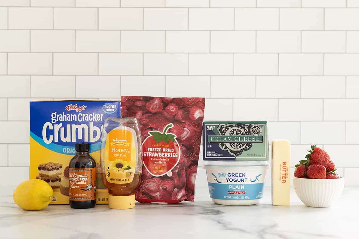 Ingredients for no bake strawberry cheesecake on countertop.