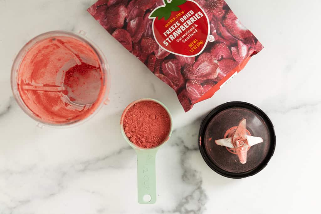 Blending dried strawberries for no bake strawberry cheesecake.