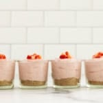 No bake strawberry cheesecakes in four glasses.