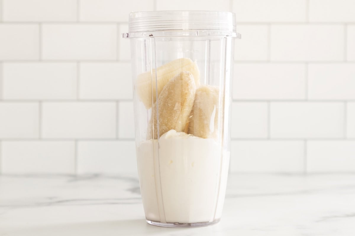 Ingredients for banana shake in blender.
