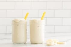 Banana shake in two glasses with straws.