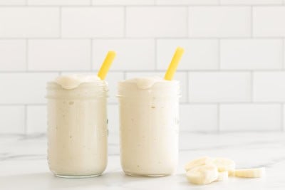 Banana shake in two glasses with straws.