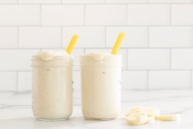 Banana shake in two glasses with straws.